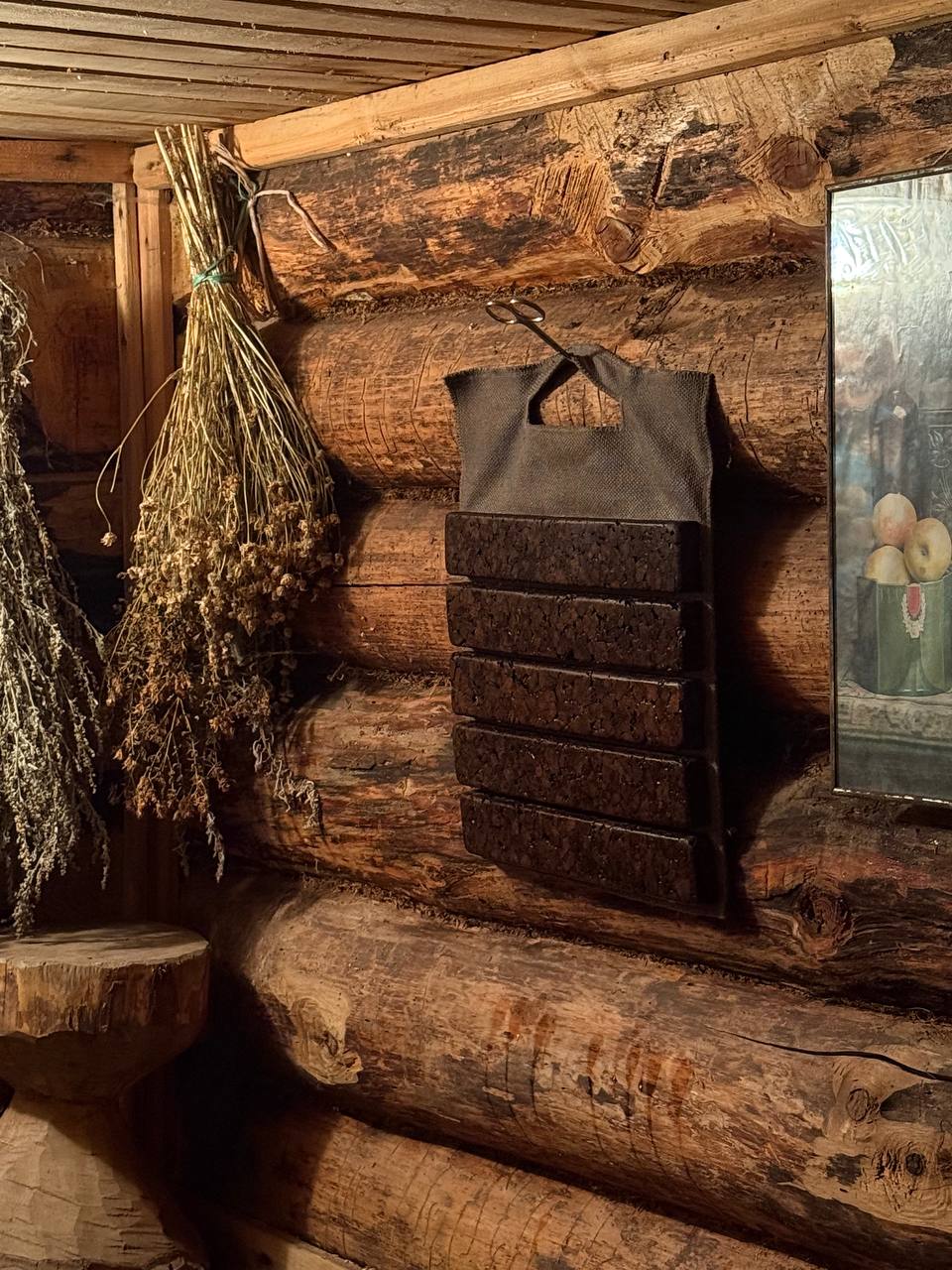 KUSH sauna mat hanging inside a traditional log sauna